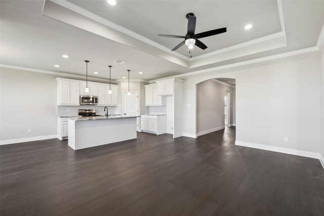 unfurnished living room with ceiling fan, sink, dark hardwood / wood-style floors, and ornamental molding