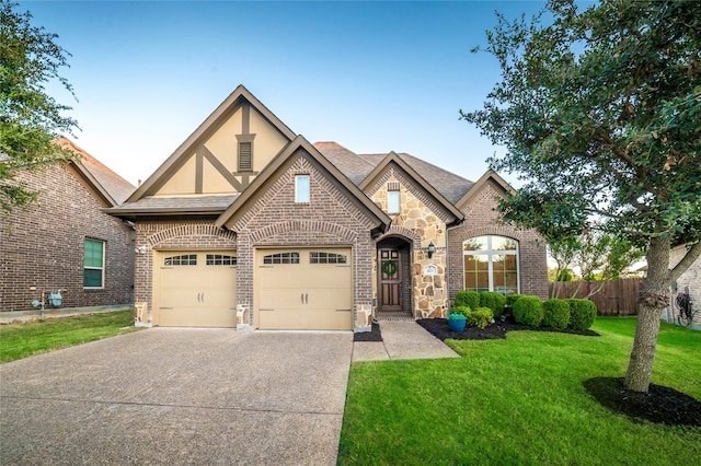 view of front of home with a front yard and a garage