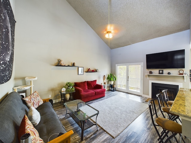 living room with a textured ceiling, dark hardwood / wood-style flooring, french doors, and high vaulted ceiling