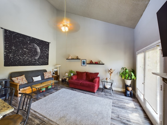 living room with ceiling fan, high vaulted ceiling, a textured ceiling, and wood-type flooring