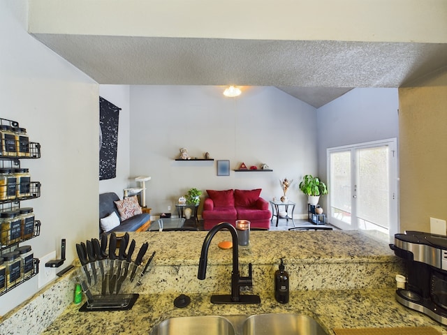 kitchen with sink and stone countertops