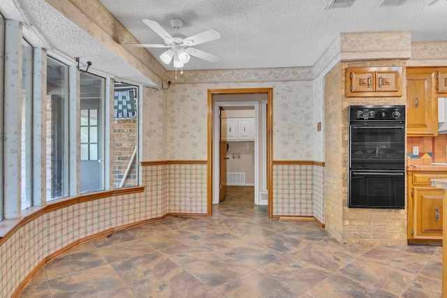 kitchen with ceiling fan, a textured ceiling, and double oven