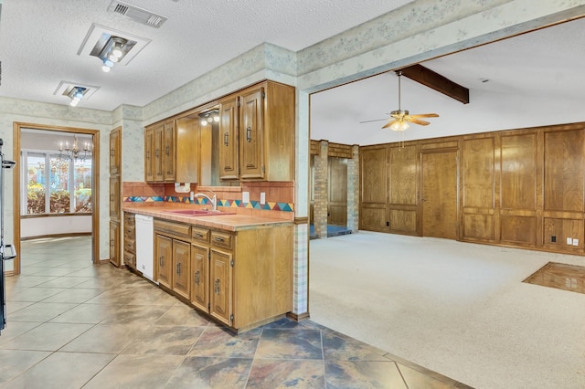 kitchen featuring light carpet, lofted ceiling with beams, a textured ceiling, and sink