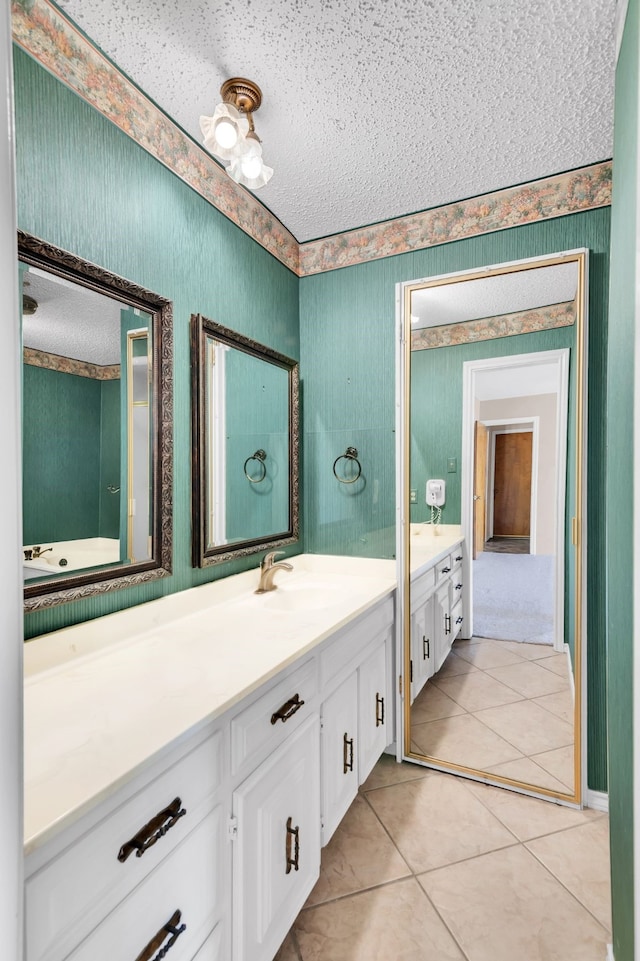 bathroom with vanity, a textured ceiling, and tile patterned flooring