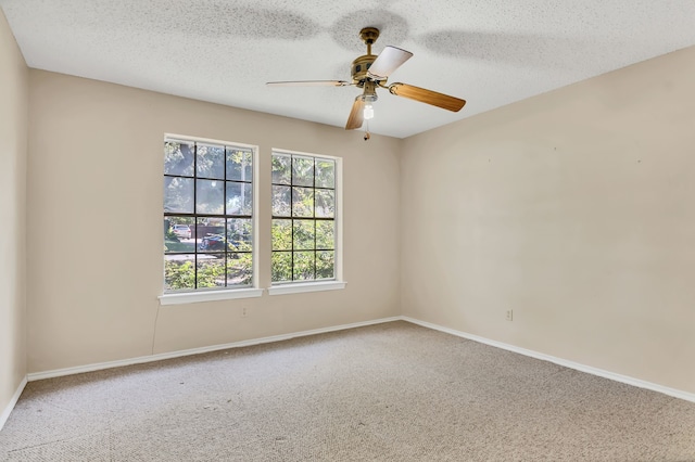 carpeted spare room featuring ceiling fan and a textured ceiling