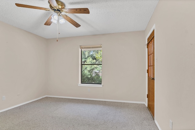 unfurnished room featuring a textured ceiling, carpet floors, and ceiling fan