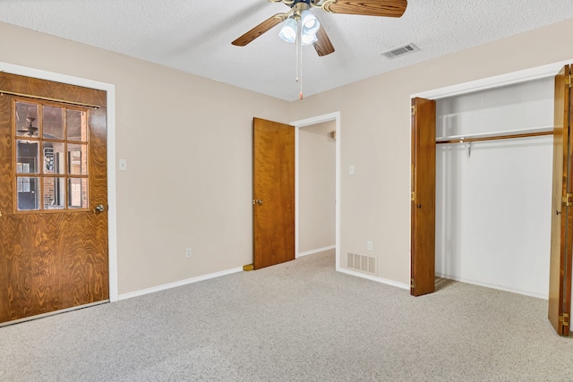 unfurnished bedroom with a closet, light colored carpet, and ceiling fan