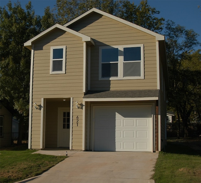 view of front facade with a front yard and a garage