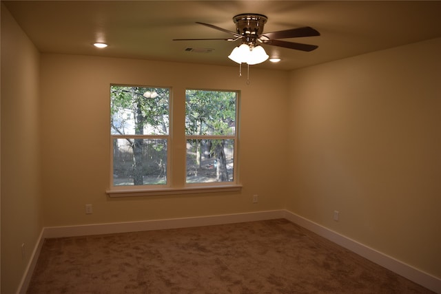 spare room featuring carpet floors and ceiling fan