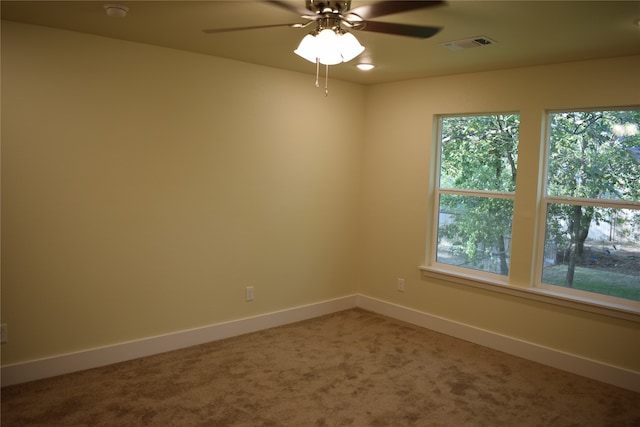 spare room featuring carpet flooring and ceiling fan