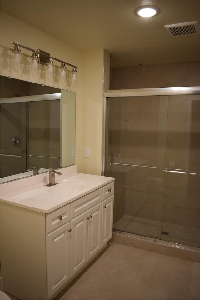 621 E Murray St, Denison, TX 75021 - bathroom featuring recessed lighting, vanity, tile patterned floors, a stall shower, and visible vents