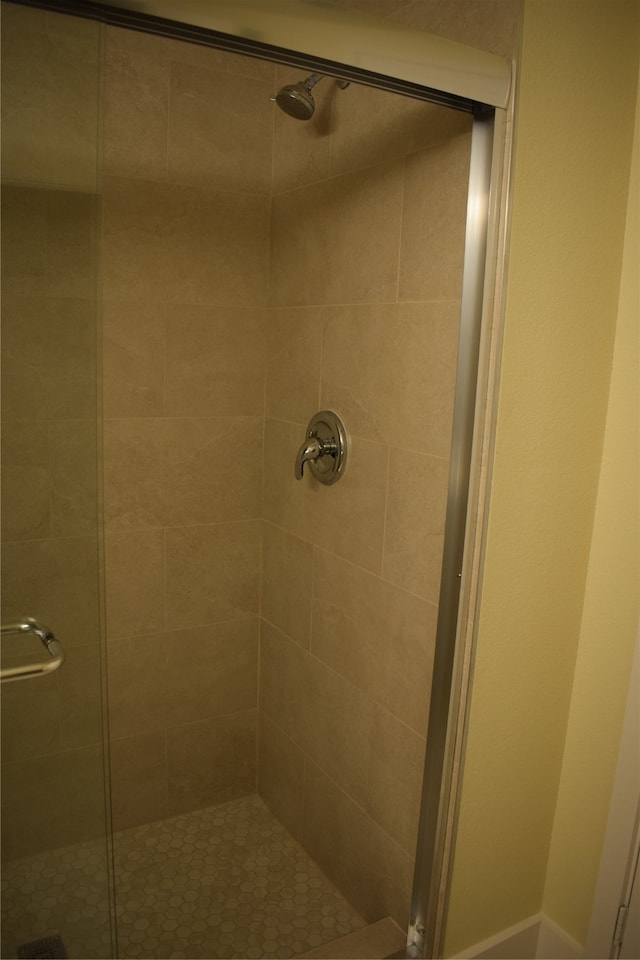 bathroom with a shower with door