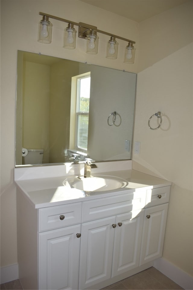 bathroom featuring vanity, toilet, and tile patterned flooring