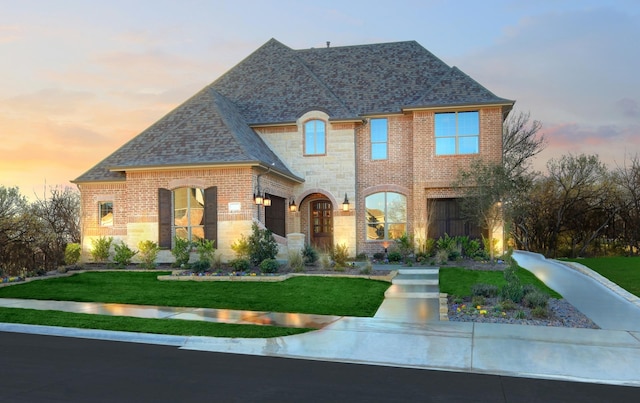 3124 Shaddock Blvd, Rockwall, TX 75032 - french provincial home with a lawn, brick siding, a shingled roof, and stone siding