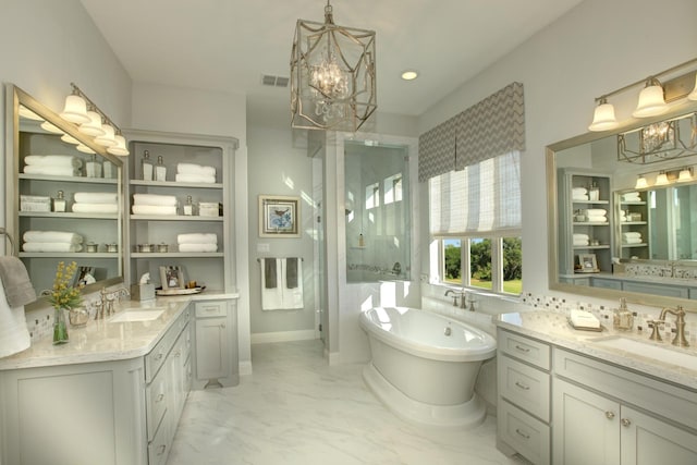 bathroom with vanity, a chandelier, and independent shower and bath