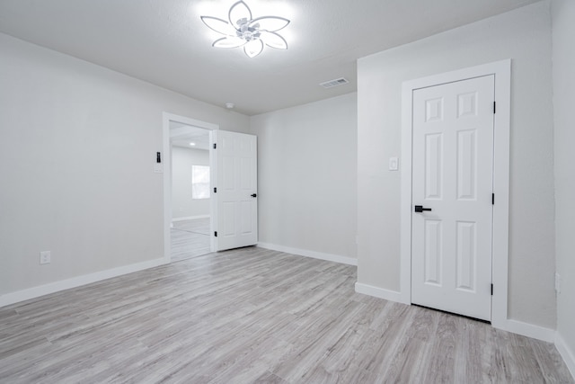 spare room featuring light hardwood / wood-style flooring