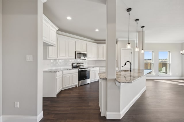 kitchen featuring light stone countertops, dark hardwood / wood-style flooring, a center island with sink, white cabinets, and appliances with stainless steel finishes