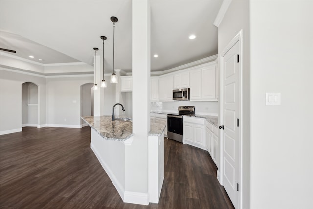 kitchen with sink, white cabinetry, an island with sink, and appliances with stainless steel finishes