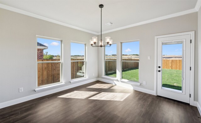 unfurnished dining area with dark hardwood / wood-style flooring, ornamental molding, and a notable chandelier