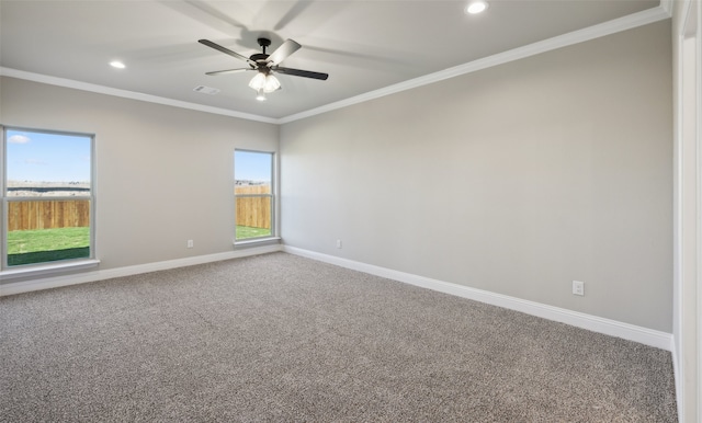 carpeted spare room with ceiling fan and crown molding