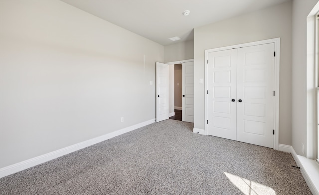 unfurnished bedroom with carpet and a closet