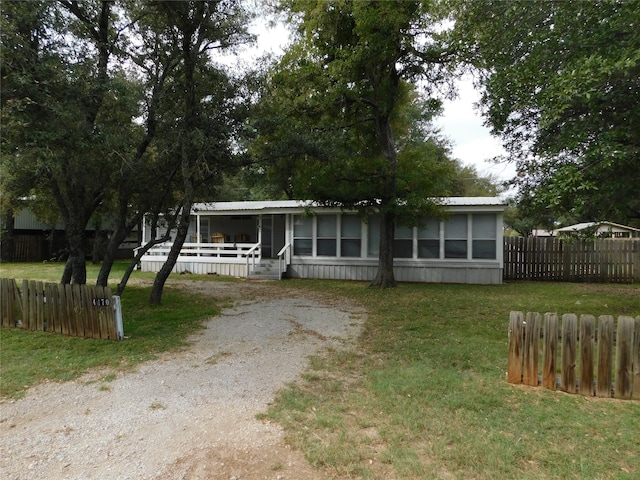 view of front of house featuring a front lawn and a sunroom