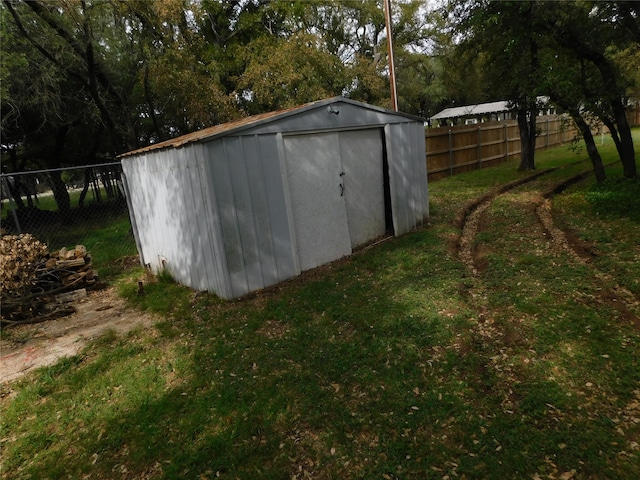 view of outbuilding featuring a yard