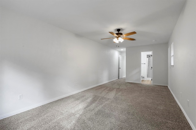 carpeted spare room featuring ceiling fan