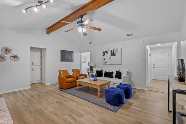 living room featuring vaulted ceiling with beams, ceiling fan, and light hardwood / wood-style flooring