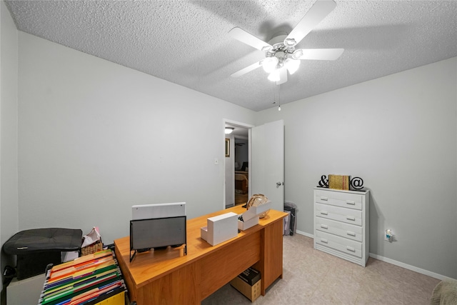 carpeted office space with ceiling fan and a textured ceiling