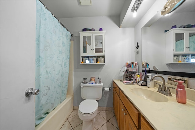 full bathroom with vanity, shower / tub combo with curtain, toilet, and tile patterned floors