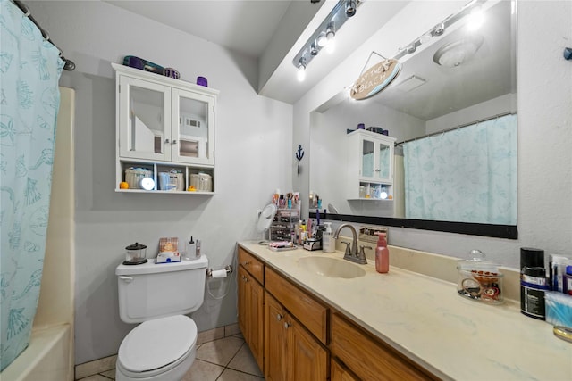 full bathroom featuring vanity, toilet, tile patterned flooring, and shower / tub combo with curtain