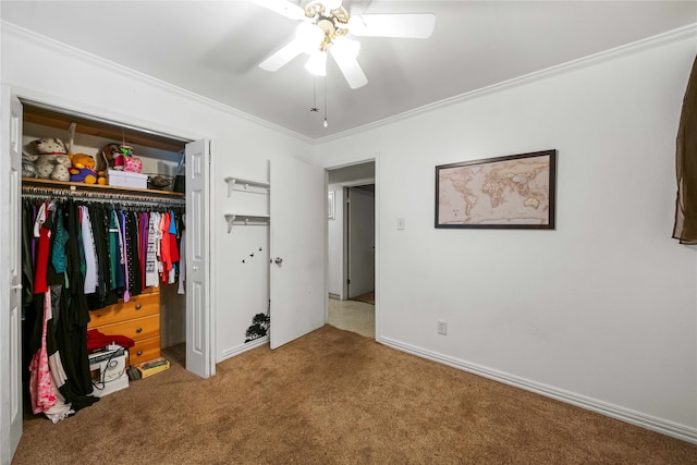 carpeted bedroom featuring a closet, ceiling fan, and crown molding