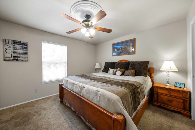 bedroom featuring light carpet and ceiling fan