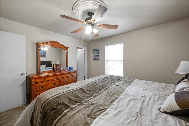 bedroom with ceiling fan and carpet flooring