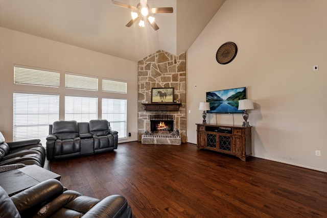 living room with dark wood-type flooring, ceiling fan, high vaulted ceiling, and a fireplace