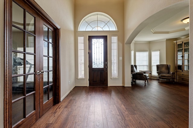 entryway featuring crown molding, dark hardwood / wood-style floors, and french doors