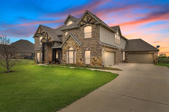 view of front of house featuring a garage and a lawn