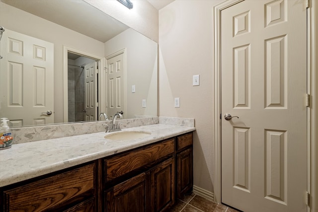 bathroom with vanity, a shower, and tile patterned floors