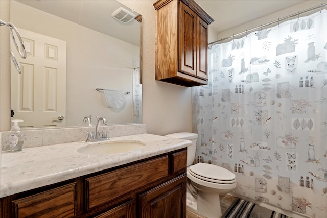 bathroom with vanity, toilet, and curtained shower