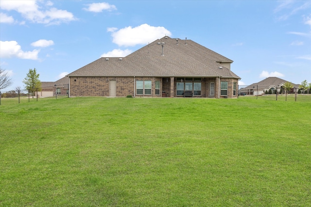 back of house with a lawn