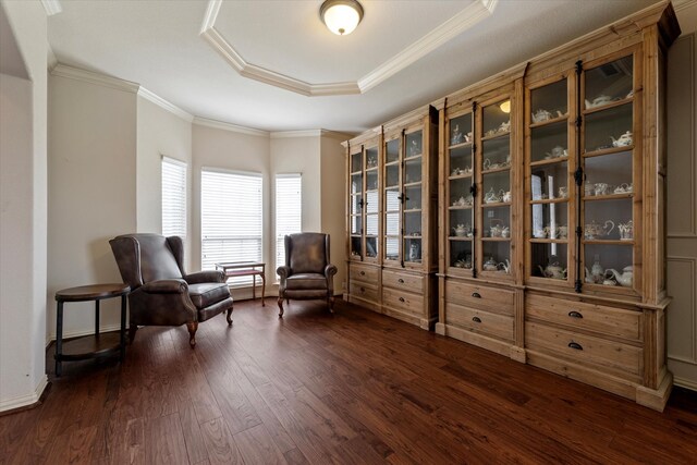 living area with dark wood-type flooring, crown molding, and a tray ceiling