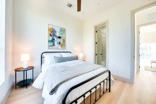 bedroom with light hardwood / wood-style floors and ceiling fan