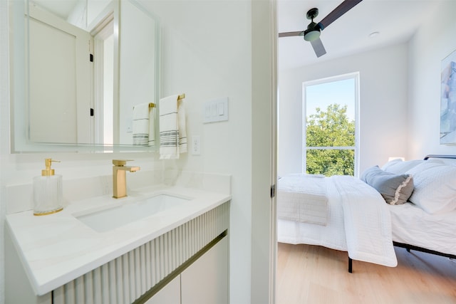 bathroom featuring hardwood / wood-style floors, vanity, and ceiling fan