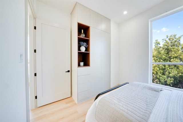 bedroom featuring multiple windows and light hardwood / wood-style floors