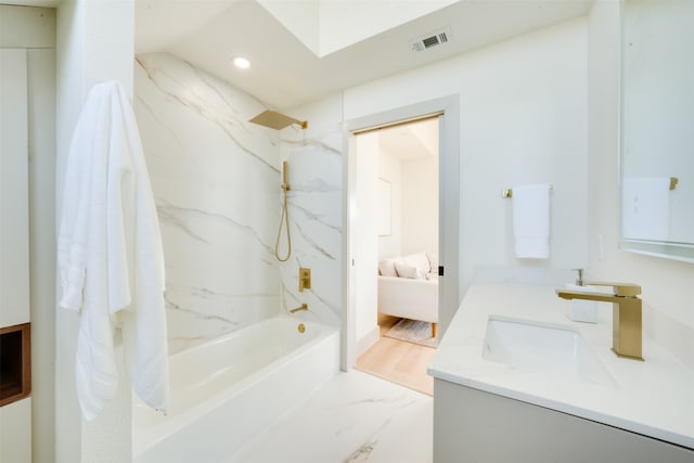 bathroom featuring hardwood / wood-style flooring, vanity, and shower / washtub combination