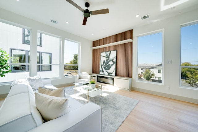 living room with ceiling fan and light wood-type flooring