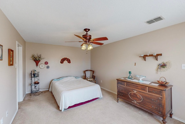 bedroom featuring light colored carpet and ceiling fan