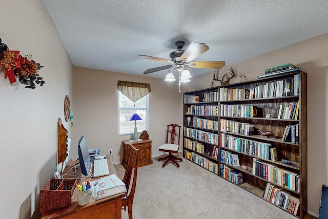 living area with a textured ceiling, carpet, and ceiling fan