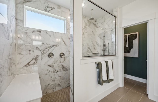 bathroom featuring a tile shower and tile patterned flooring